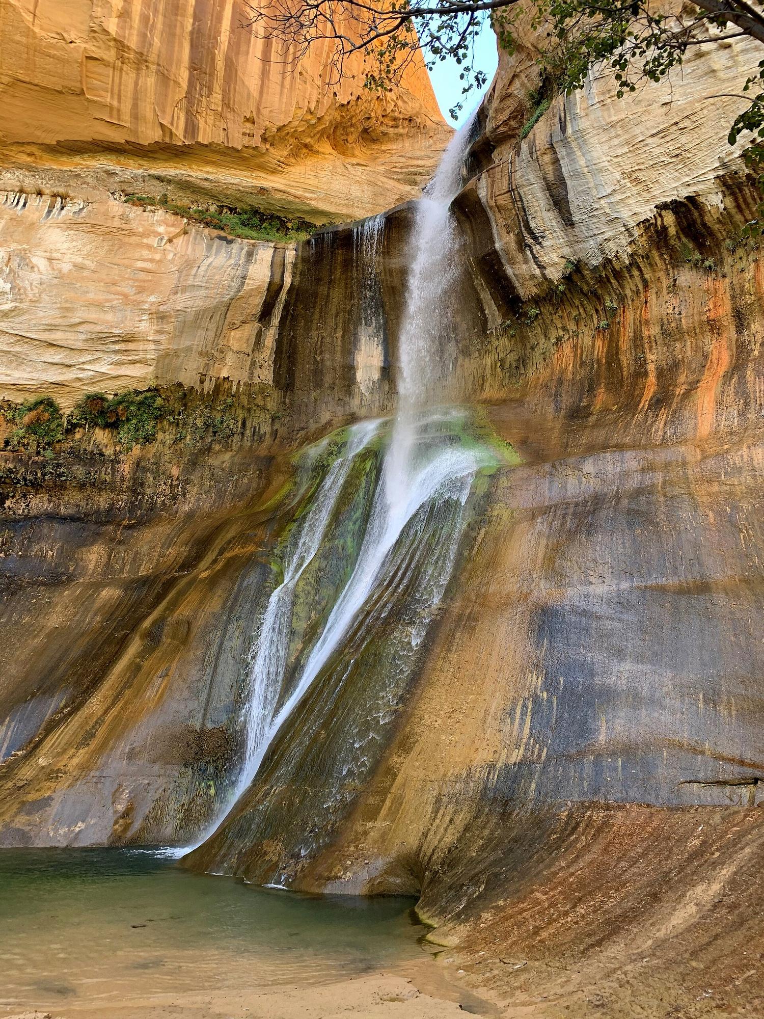 Lower Calf Creek Falls pouring over a streaked sandstone wall near Boulder, Utah